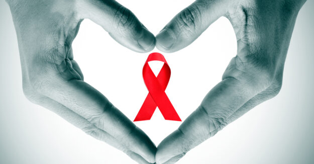 Aids Walk 2019 hands forming a heart with the red ribbon in the middle of the heart representing AIDS awareness