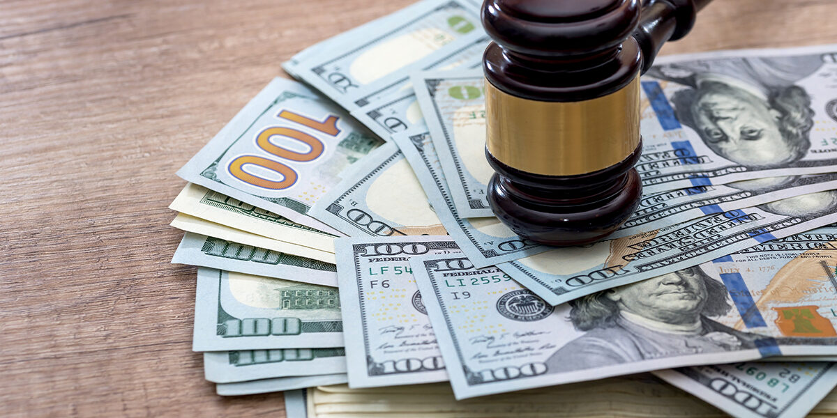 Hernia mesh litigation update article featured image showing gavel of law pounding a pile of one hundred dollar bills