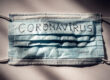 COVID 19 Delays Hernia Mesh Trials featured image showing a face mask with CORONAVIRUS written on it