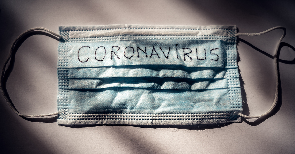 COVID 19 Delays Hernia Mesh Trials featured image showing a face mask with CORONAVIRUS written on it