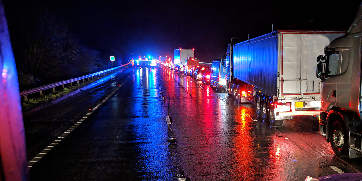 Truck Accidents on the highway at night time with a lot of traffic backed up for miles