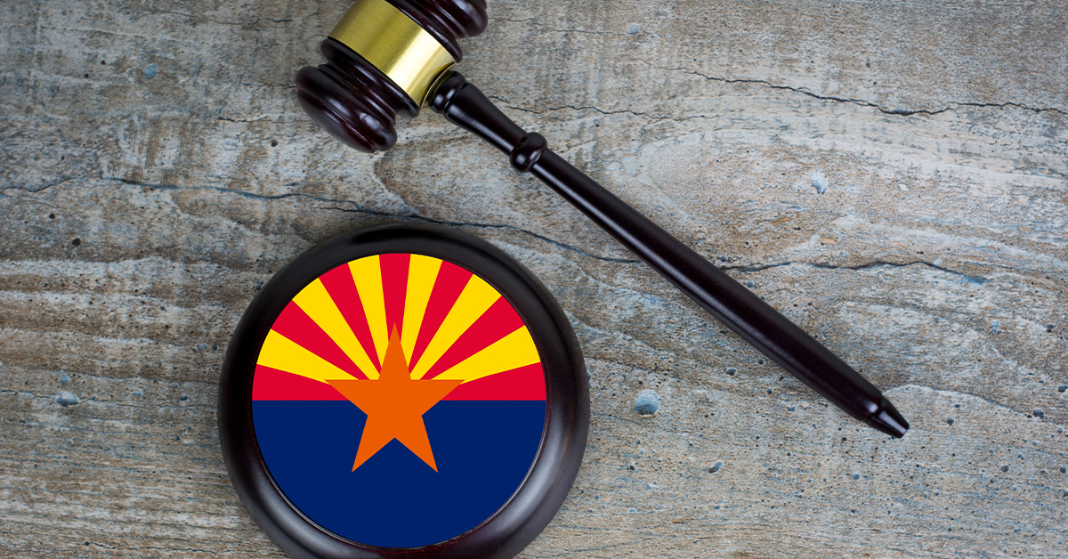 Arizona Human Trafficking Undercover Sting Results in 34 Arrests gavel laid next to round block with Arizona state flag printed on it