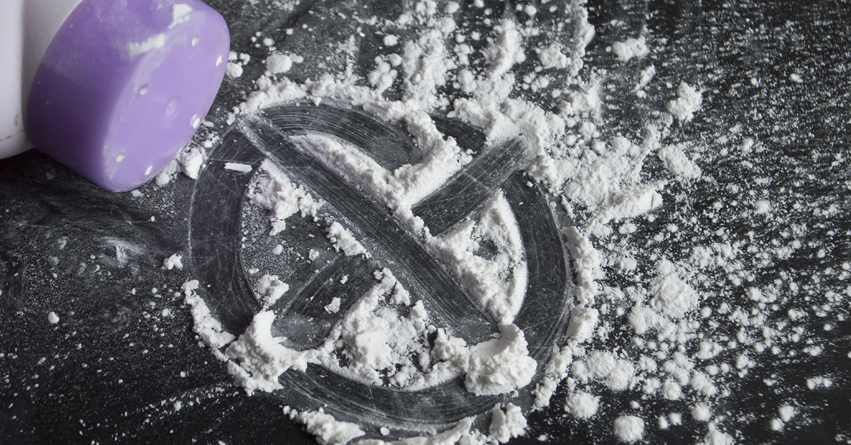 Johnson & Johnson Ordered to Pay $120M in Talcum Powder Lawsuit big letter X created out of powder with purple bottle tipped over