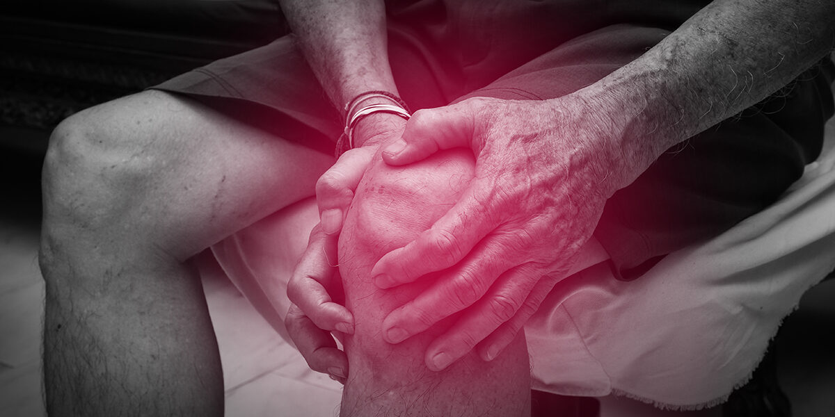 Exactech Knee Replacement feautred image with man clutching his injured knee